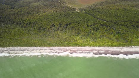 Beach-Waves-Crashing-Into-Maori-Beach-In-New-Zealand---aerial-shot