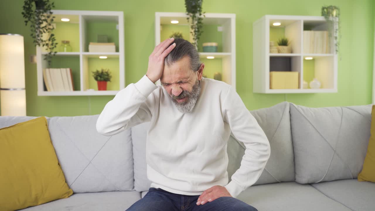 두통을  ⁇ 고 있는 중년 남성