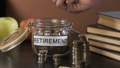 closeup of man takes savings from glass