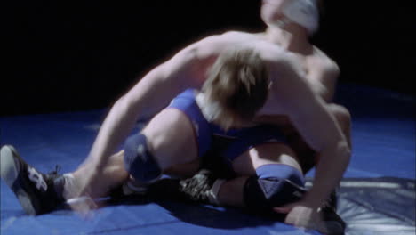 two wrestlers struggle for dominance