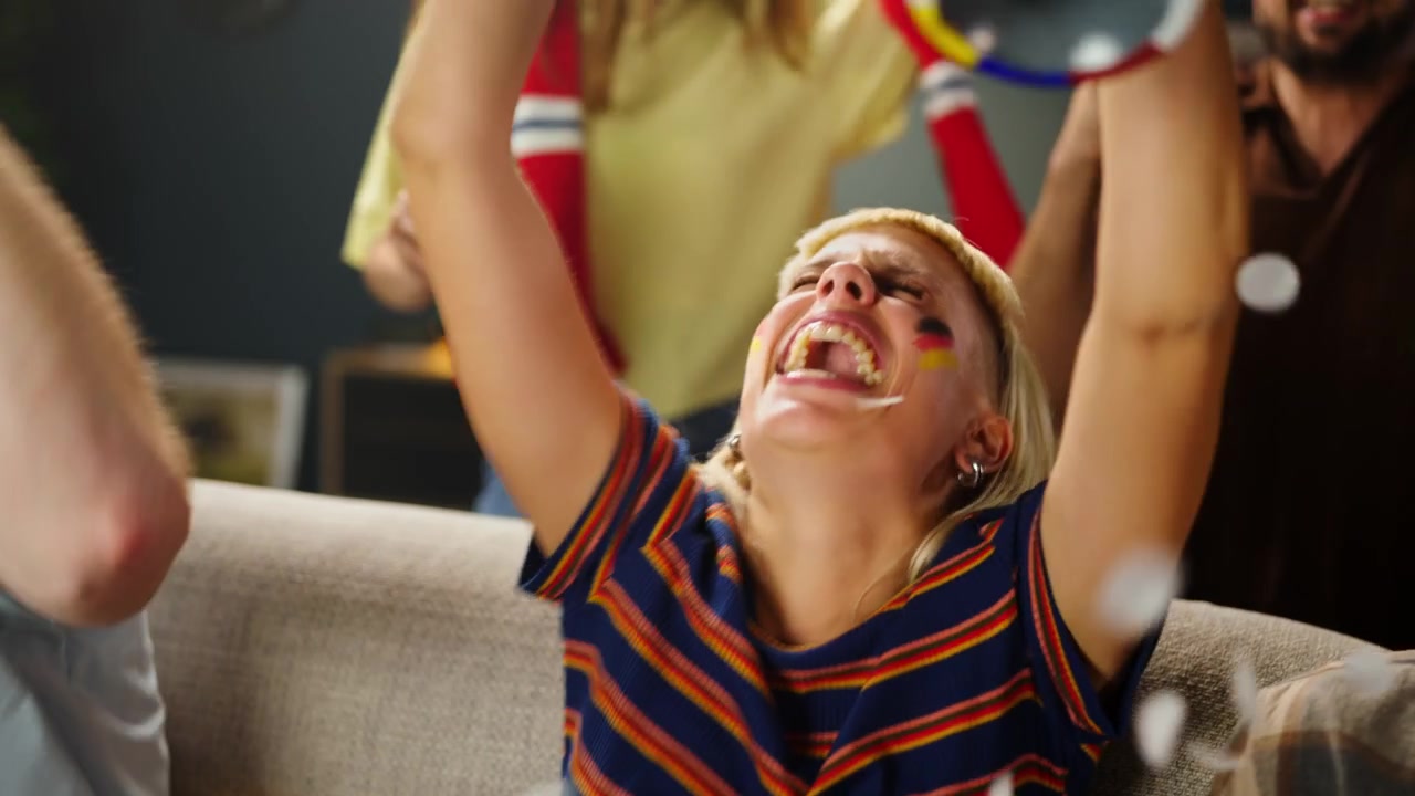 German Soccer Fans Celebrating Goal While Watching Match at Home