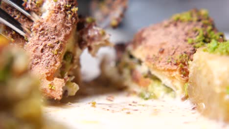 close-up of baklava with syrup and fork