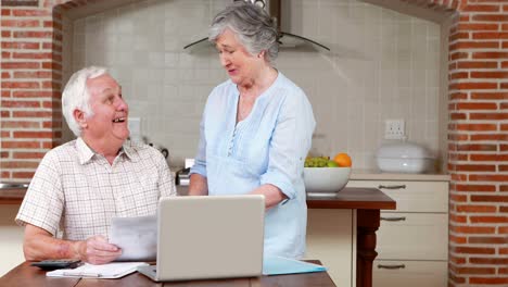 Senior-couple-paying-their-bills-with-computer