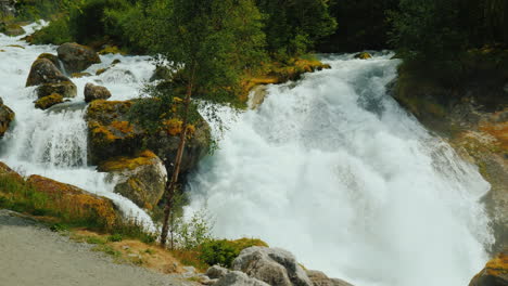 waters of the waterfall at the bottom of the bridge in the distance meltwater from the glaciers in t