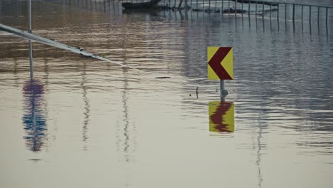 flooded road with submerged traffic signs and reflections in water during budapest flood of 2024