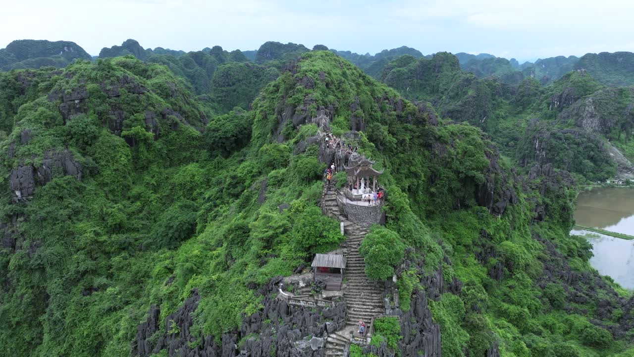 Ancient mountain pagoda hike in lush green Ninh Binh landscape, peaceful and scenic