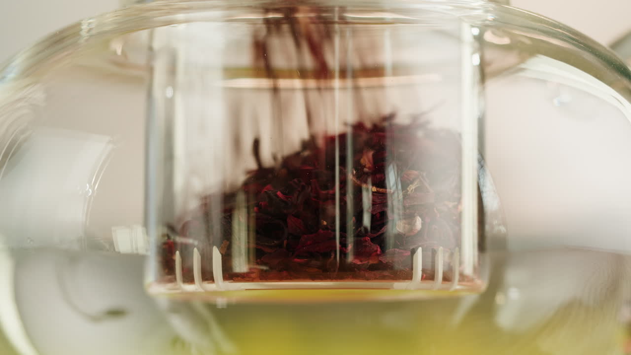Loose Leaf Tea Being Poured into a Teapot Infuser
