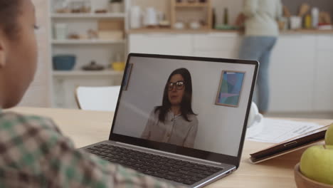 student having a video call with a teacher