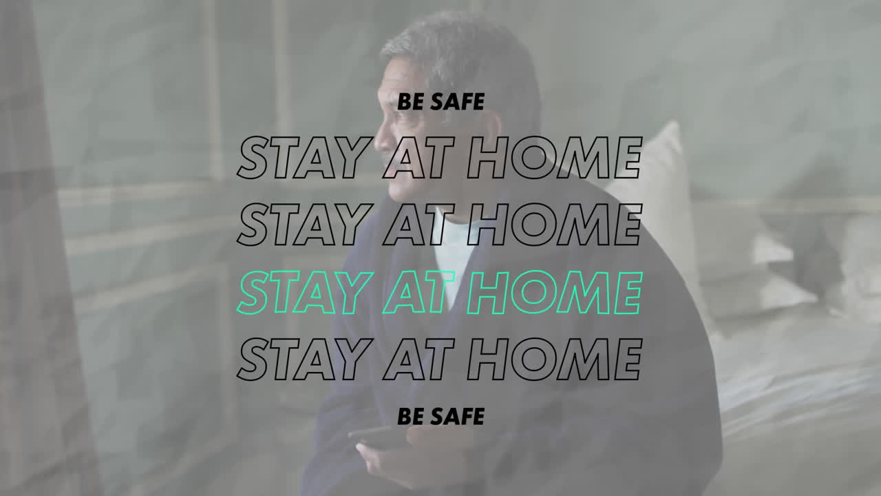 Animation of stay at home be safe text over worried senior man at home