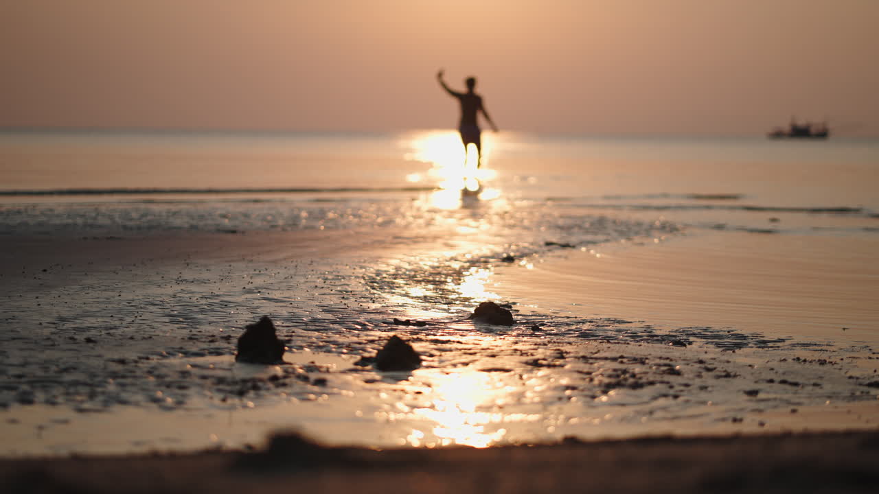 Person enjoying the sunset on the beach