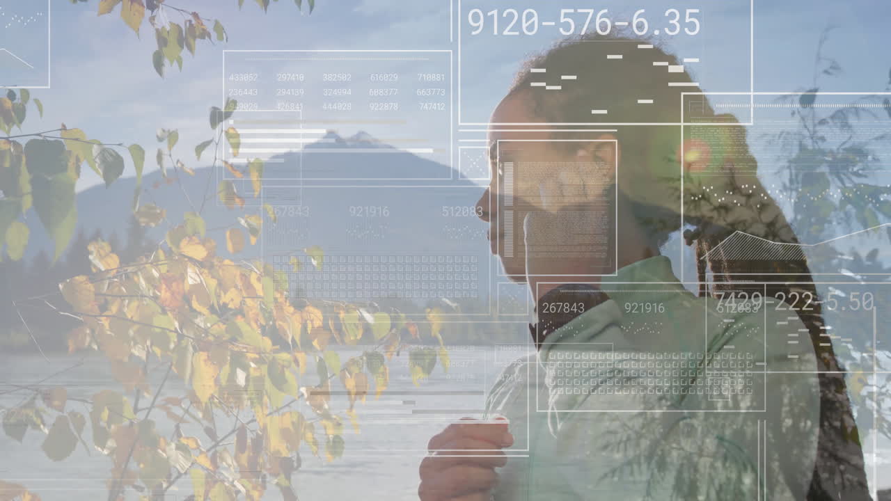 Data processing animation over person standing by lake with mountains and trees