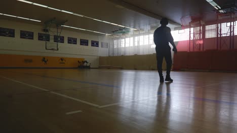 Male-Walking-Into-View-and-Looking-at-Court---Strong-Athletic-Muscular-Black-Man-Standing-On-Basketball-Court-Looking-Around-In-4K