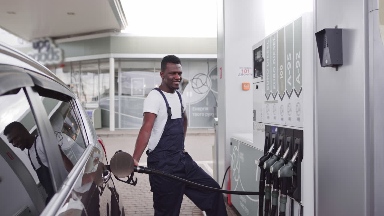 Man fueling a car at a gas station