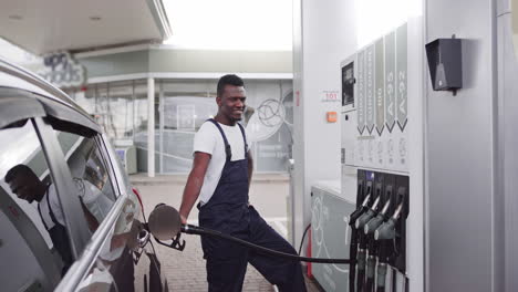 man fueling a car at a gas station