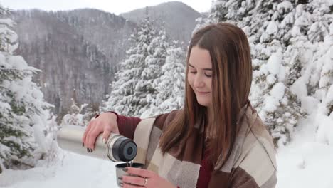 young pretty girl drinks hot tea on the date in winter forest young pretty girl drinks hot tea on the date in winter forest