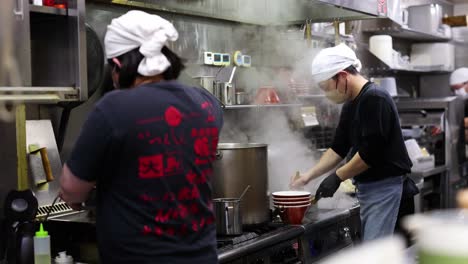 chefs working together in a steamy kitchen