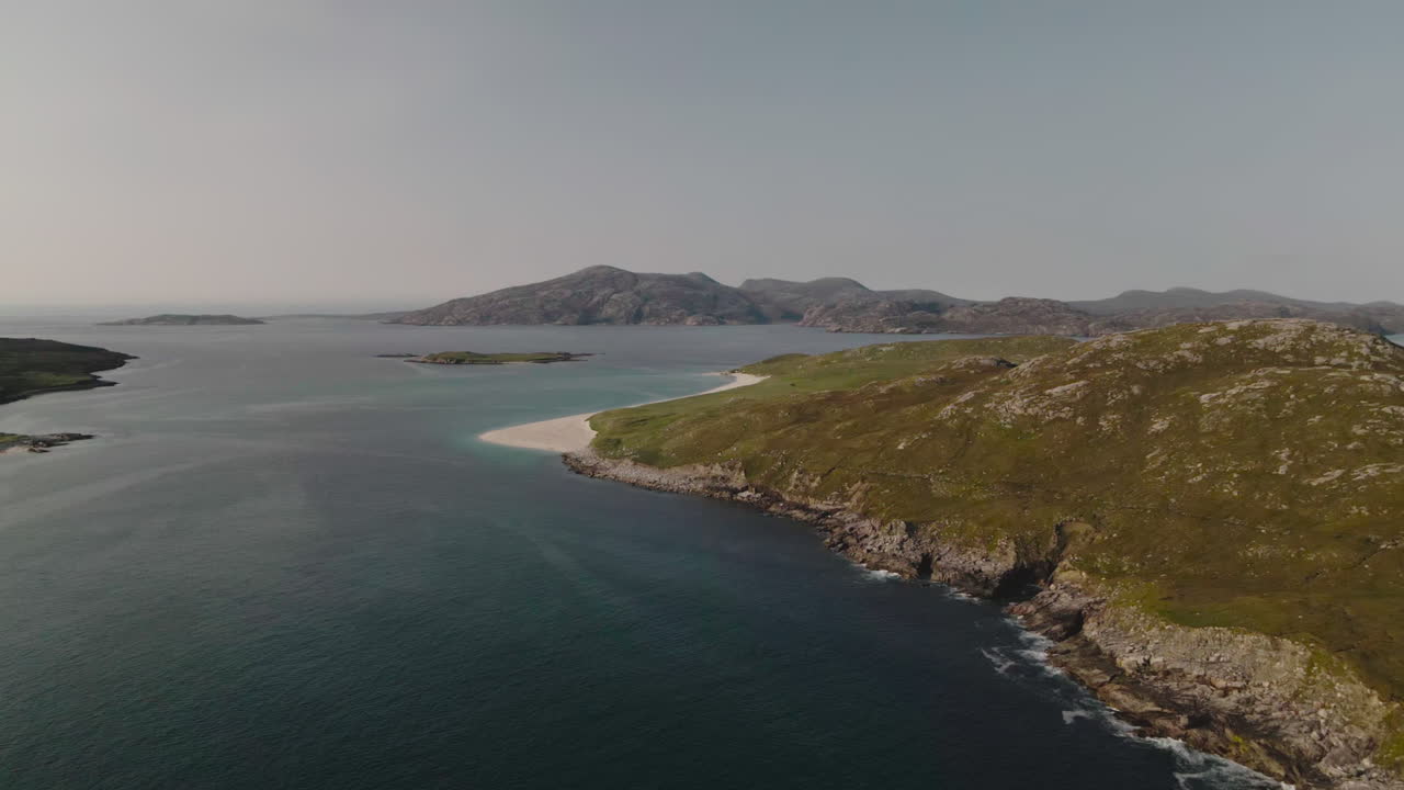Aerial view of small beach in Outer Hebrides featuring sea and hills in background
