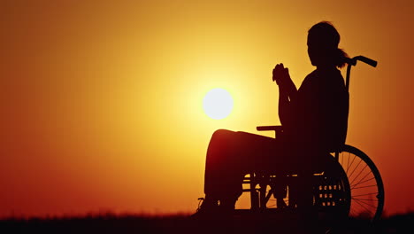 disabled woman contemplating sunset