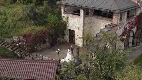 lovely newlyweds caucasian bride groom walking in park, holding hands, wedding couple family