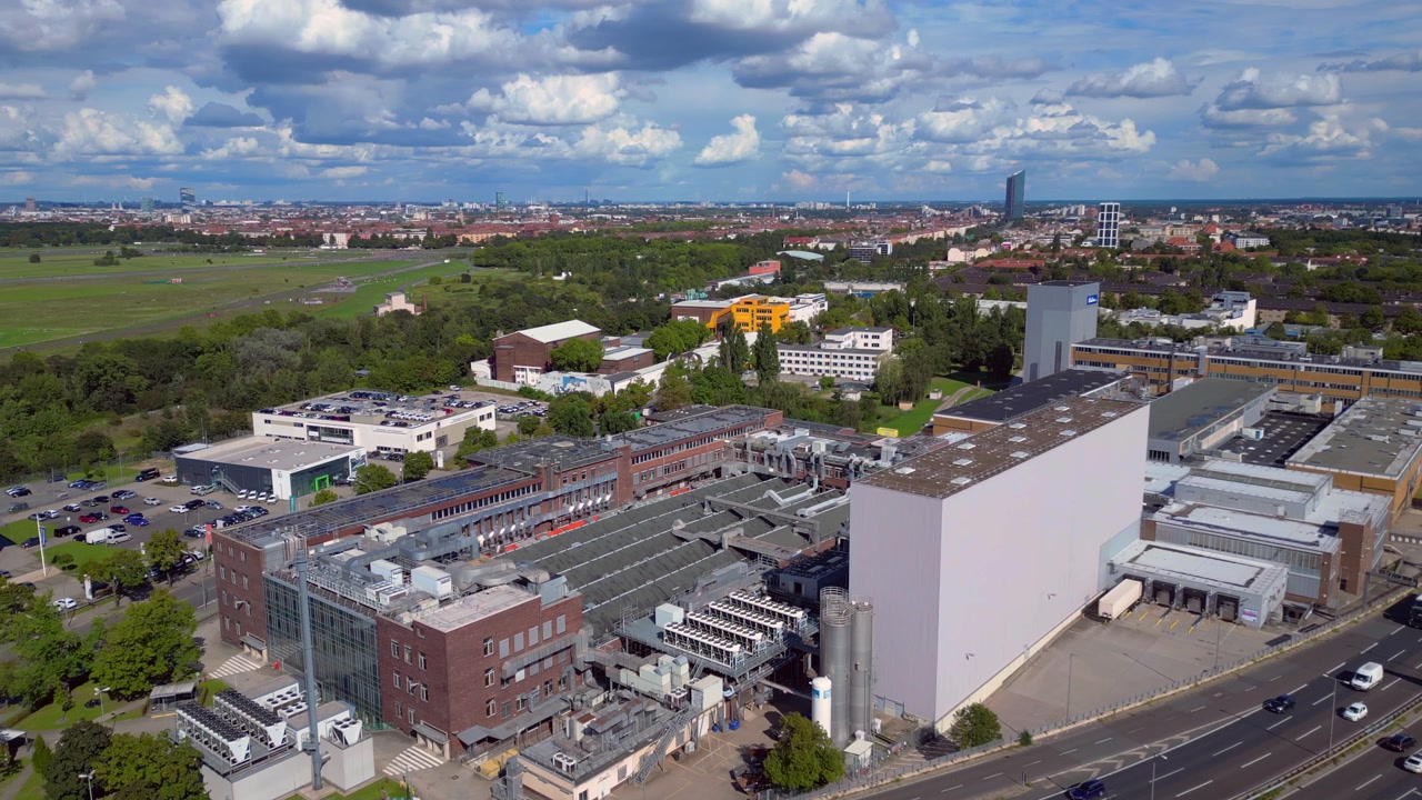 Berlin's industrial area with Bahlsen, Procter Gamble Gillette, Ufa Film factories and highways under a sunny sky. Nice aerial view flight panorama overview drone