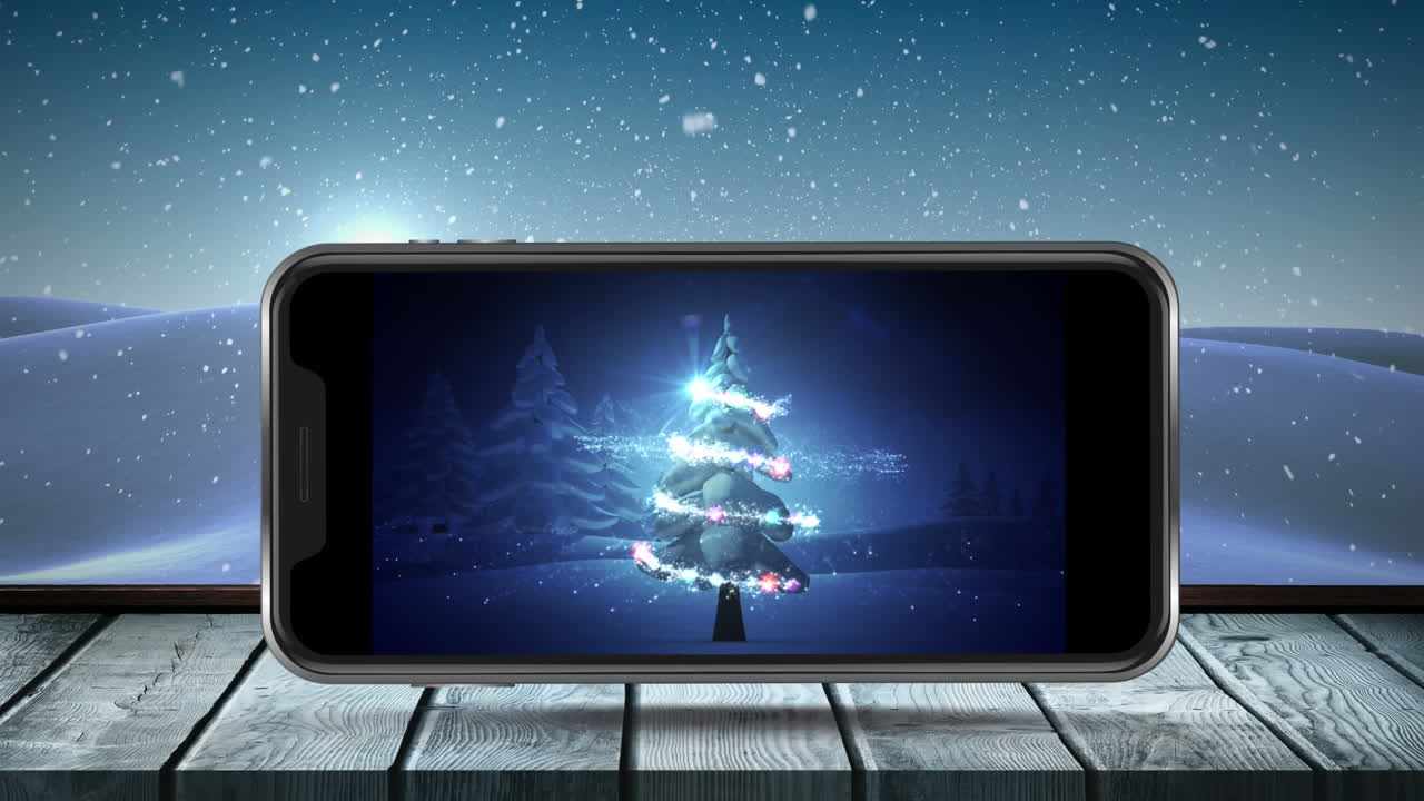 Animation of christmas tree on smartphone screen with winter scenery and snow falling