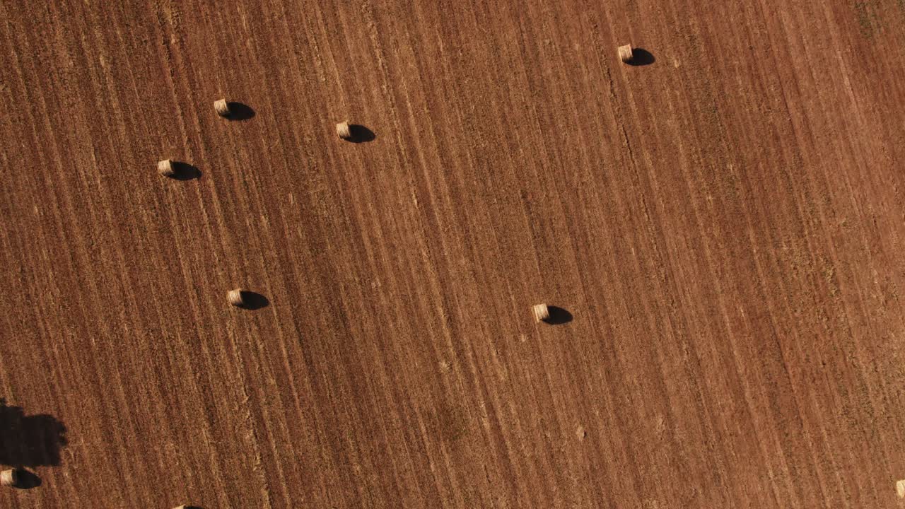 Aerial View of Hay Bales in plowed field