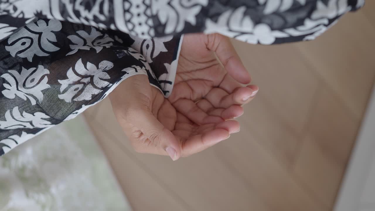 Close-up of hands with floral patterned clothing