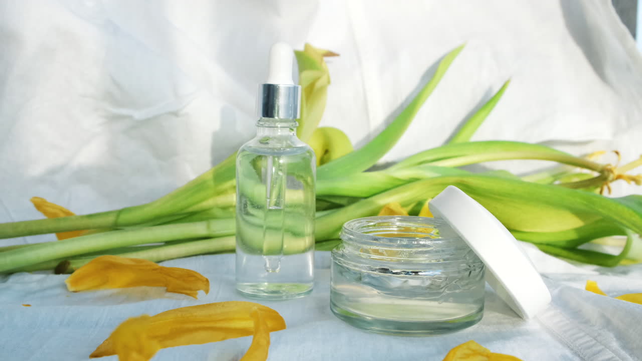 Hand applying skincare products with flowers