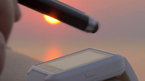 using touchscreen smartwatch at sunset