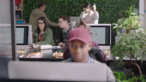 young group of business people working team leader woman training intern pointing at computer screen sharing ideas showing support colleagues collaborating in diverse modern office