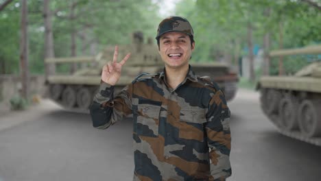 happy indian army man showing victory sign