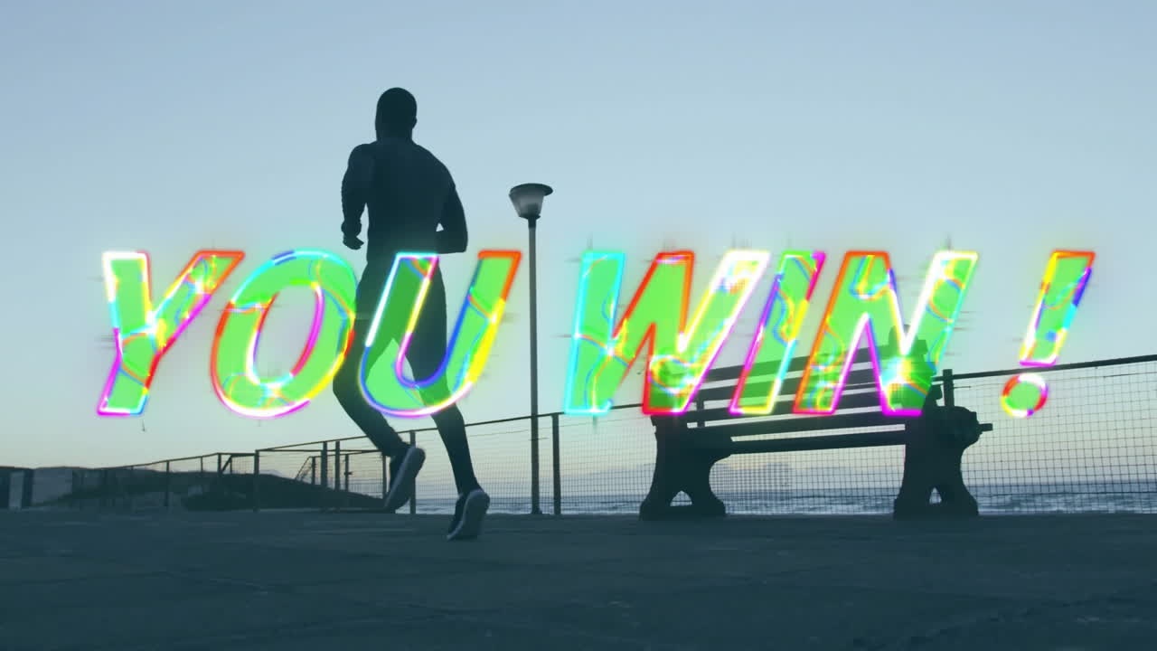 Runner silhouetted with animation of YOU WIN! text in vibrant sunset colors