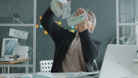 man celebrating success with money