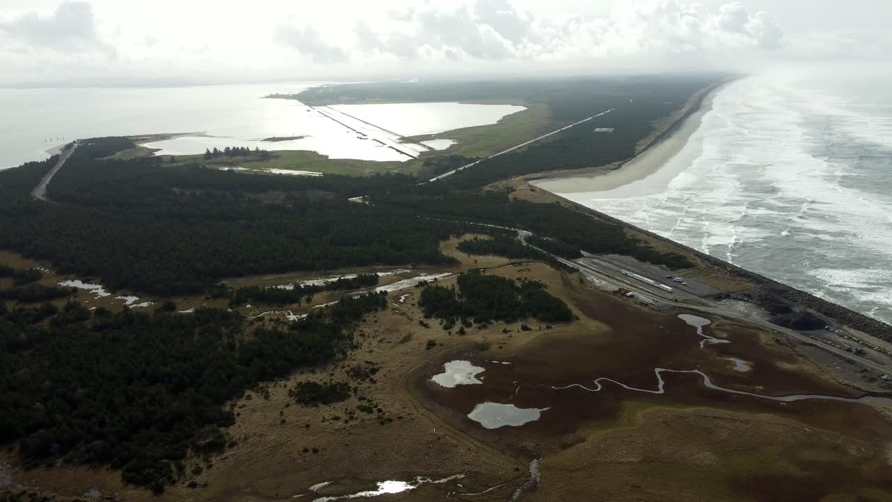 US, Oregon, Astoria, Fort Stevens, 2025-03-21 - Drone view of the Columbia River at the Pacific Ocean at Fort Stevens State Park. This early 1900's railroad trestle was used to build the rock jetty.