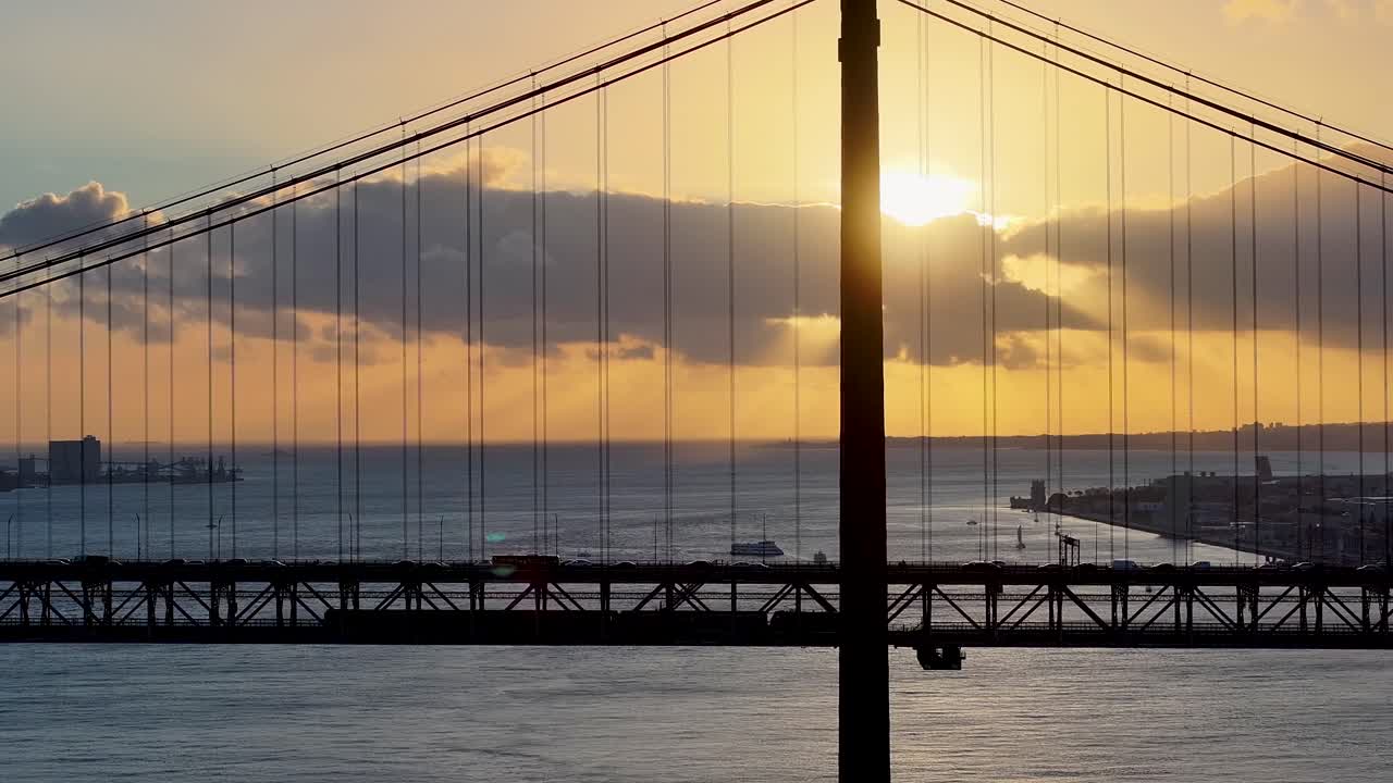 Sunset Sky Over 25 Of April Bridge At Lisbon In Lisbon District Portugal. Sunset Downtown. Freeway Road Landscape. 25 Of April Bridge At Lisbon In Portugal. Public Transport Scenery