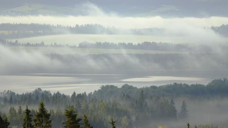Panoramic-shot-of-fog-rolling-over-the-lake-landscape