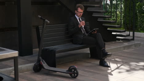 businessman taking a coffee break outdoors