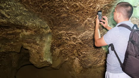 Tourist with a Backpack in the Cave Speleology Cave Dungeon Tourist with a Backpack in the Cave Speleology Cave Dungeon Dark Tunnel Underground Excavations