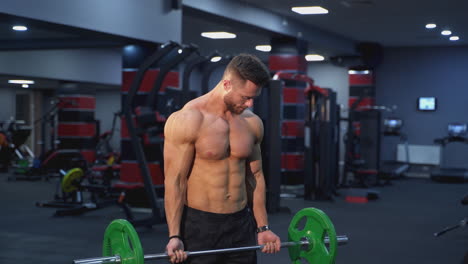strong athlete lifting barbell in gym. handsome man doing exercise with a heavy barbell. sportsman doing strength and endurance exercises with barbell. weightlifting.