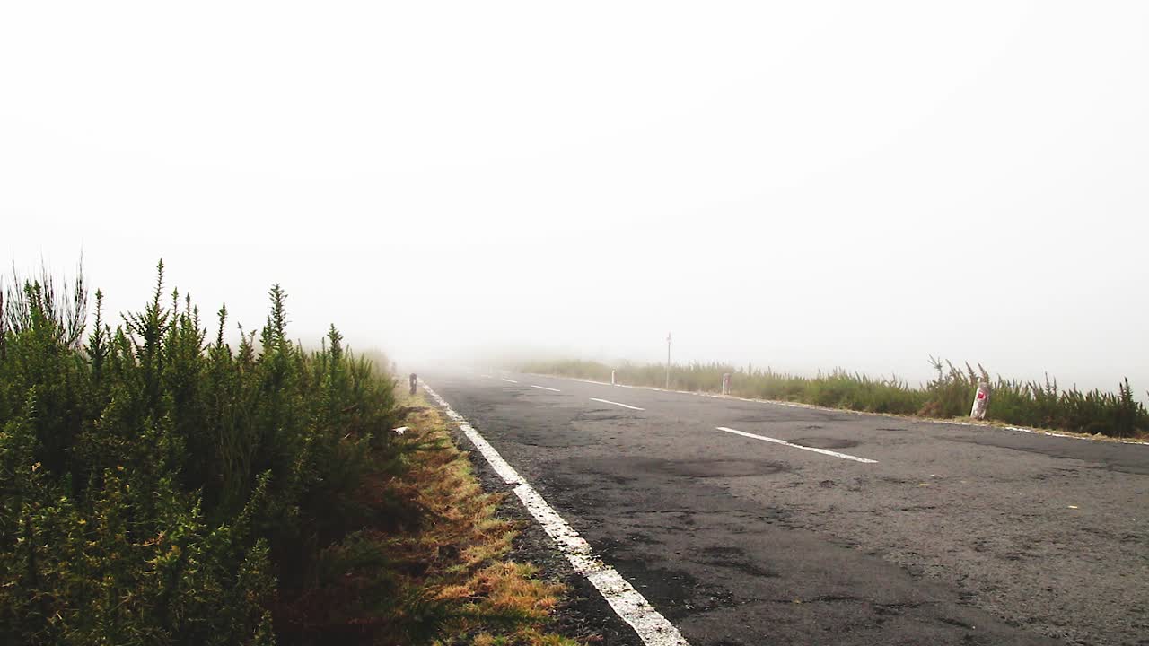 White van passing by at Paul da Serra plateau on the way to Fanal, Madeira. wide shot