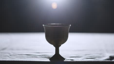 Religious-Concept-Shot-With-Chalice-On-Altar-With-Spotlight-Behind-2