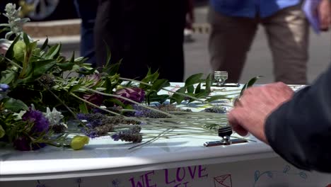 closeup shot of a funeral casket in a hearse or chapel or burial at cemetery