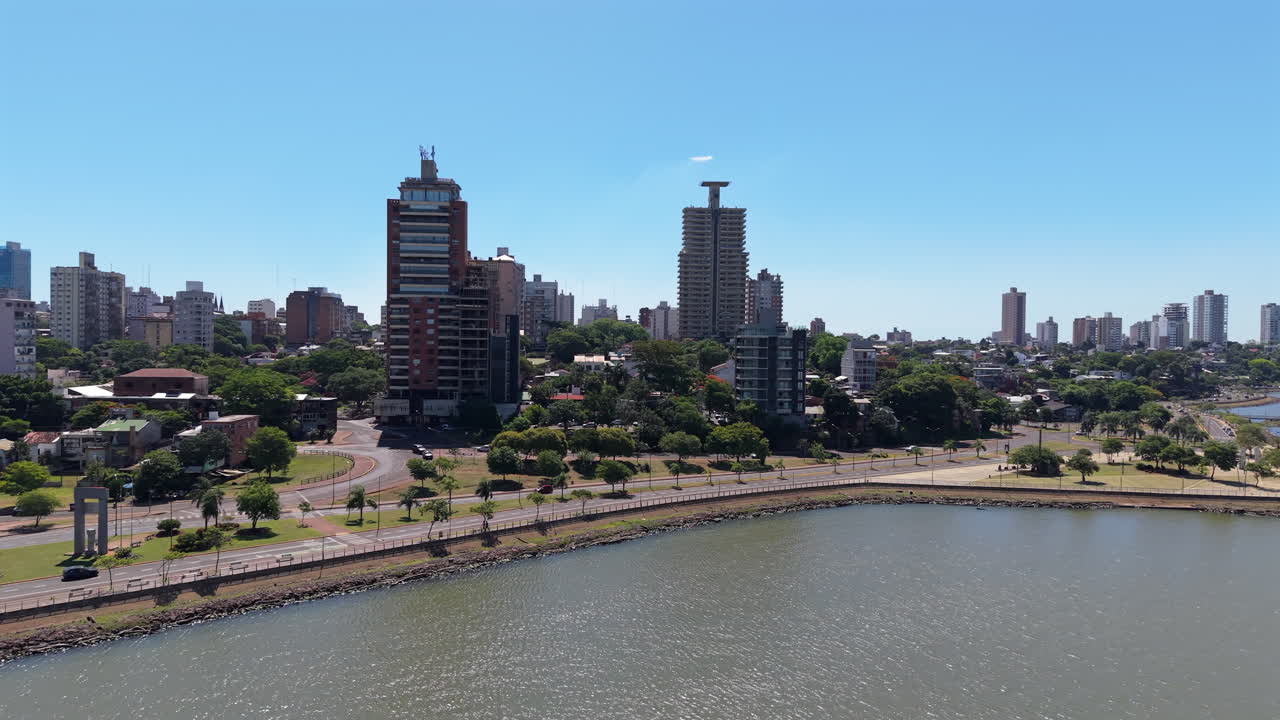 Pan drone shot of Posadas cityscape with Parana River in Misiones, Argentina