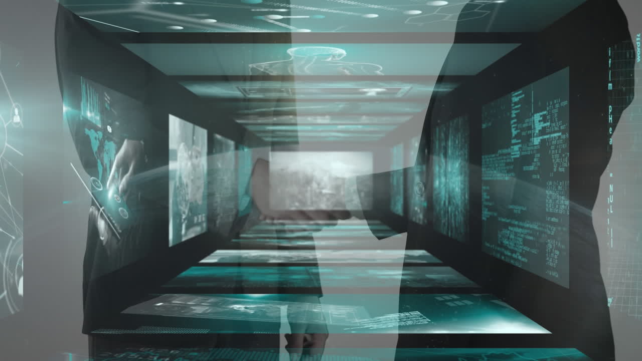 Screens with data processing over mid section of businessman and businesswoman shaking hands