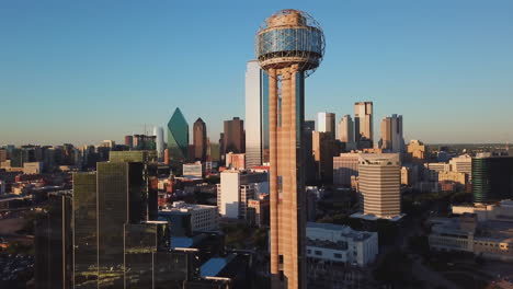 aerial drone footage of downtown dallas skyline and reunion tower at sunset golden hour