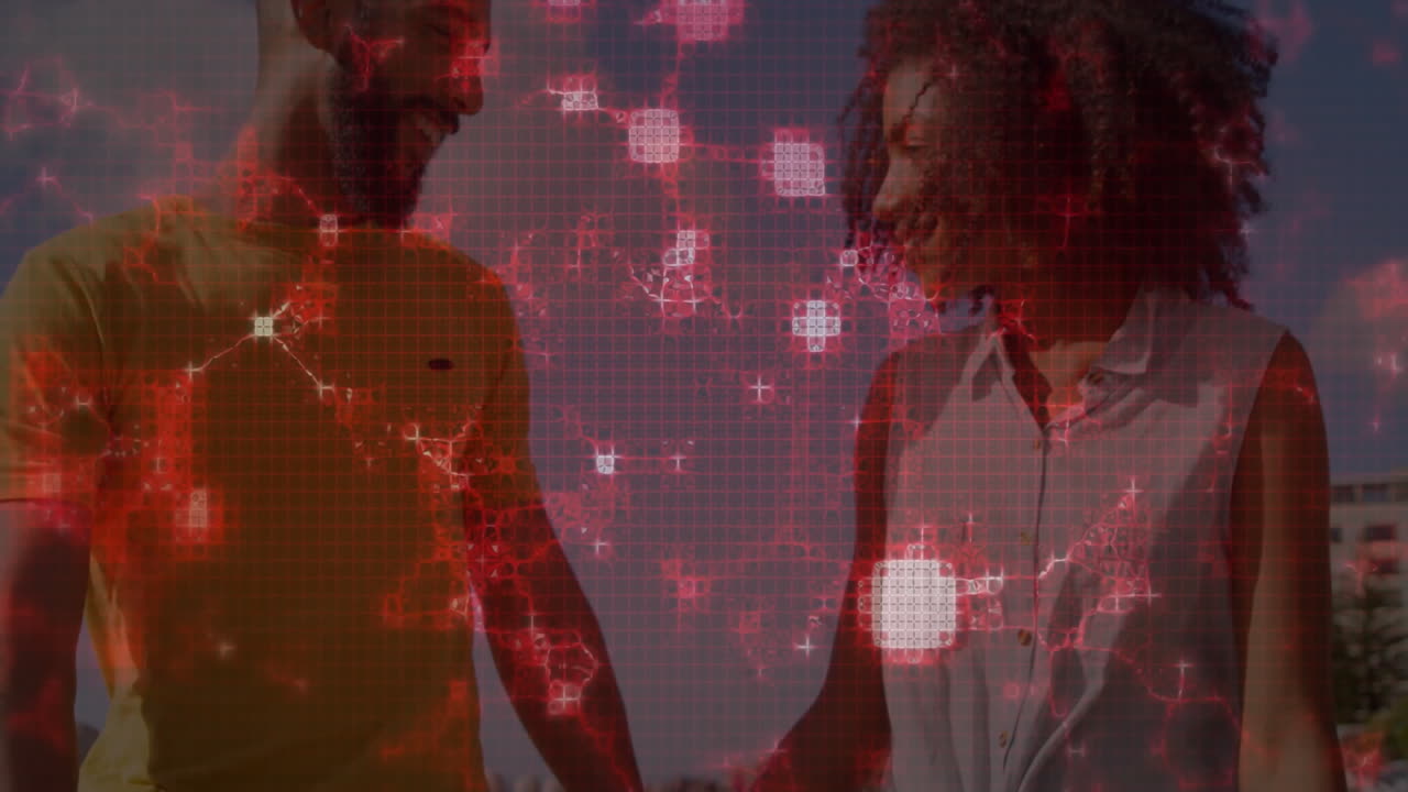 Red digital network animation over diverse couple smiling and holding hands