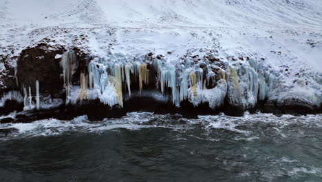 Small-waves-lapping-against-the-frozen-mountainside