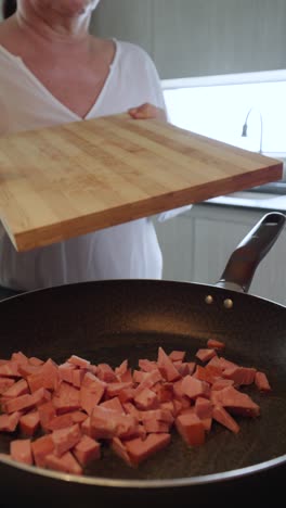 cooking sausage in a pan