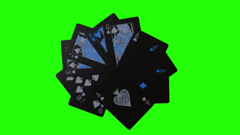 shot of black cards rotating on a green screen