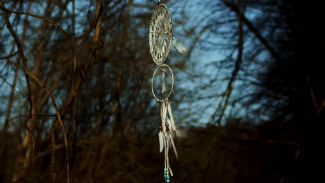 ornate dreamcatcher hangs in stark foreground contrast, medium